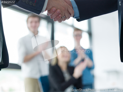 Image of cloasing the deal in modern office interior