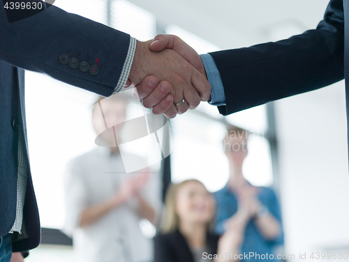 Image of cloasing the deal in modern office interior