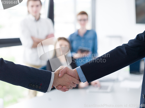 Image of cloasing the deal in modern office interior