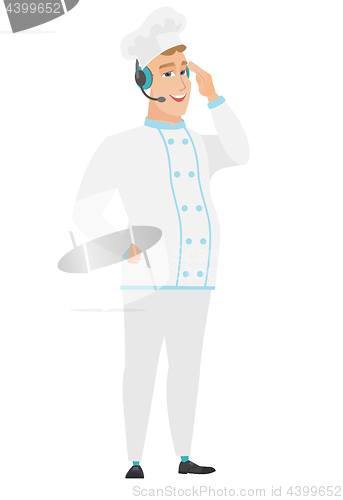 Image of Caucasian chef cook in headset with microphone.