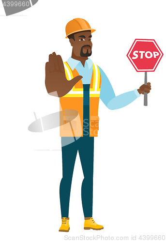 Image of African-american builder holding stop road sign.