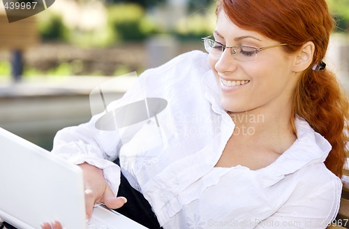 Image of smiling businesswoman with laptop computer