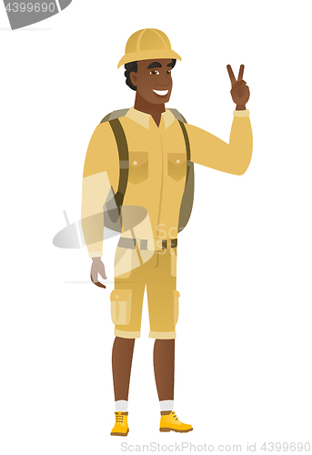 Image of African-american traveler showing victory gesture.