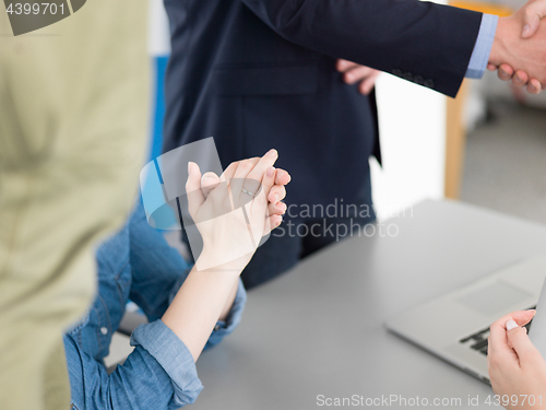 Image of cloasing the deal in modern office interior