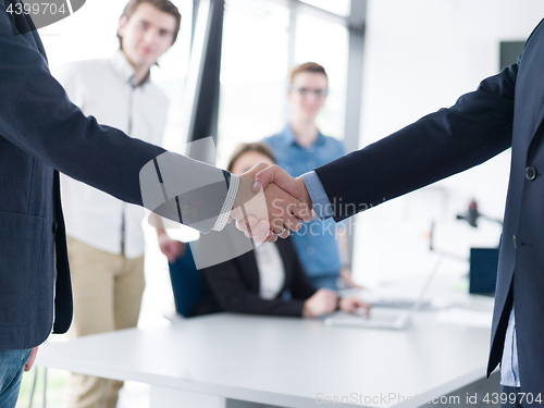 Image of cloasing the deal in modern office interior