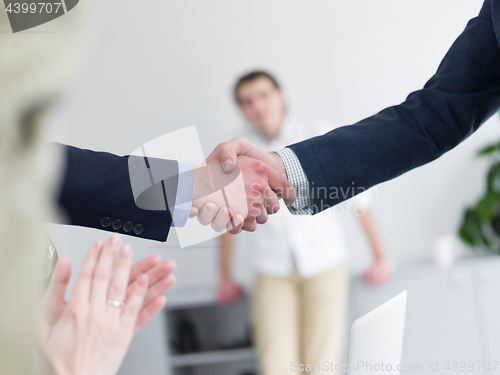 Image of cloasing the deal in modern office interior