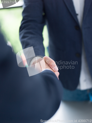 Image of cloasing the deal in modern office interior