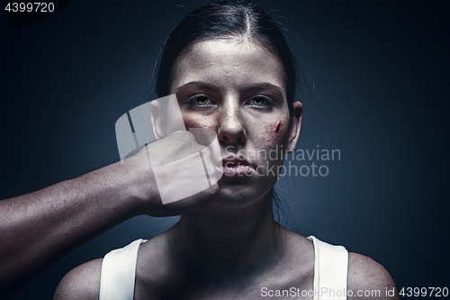 Image of Male fist against kidnapped young woman in the background