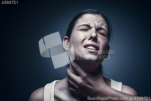 Image of Home violence - young woman is choked by man\'s hand