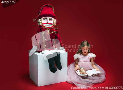 Image of The beauty ballerina sitting with nutcracker