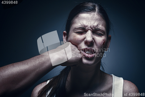 Image of Male fist against kidnapped young woman in the background