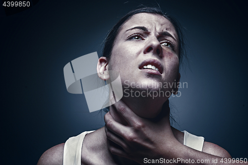 Image of Home violence - young woman is choked by man\'s hand
