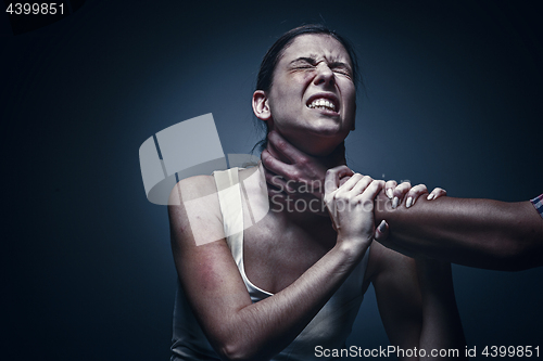 Image of Home violence - young woman is choked by man\'s hand