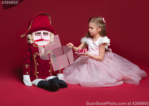Image of The beauty ballerina standing with nutcracker