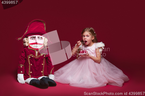 Image of The beauty ballerina standing with nutcracker