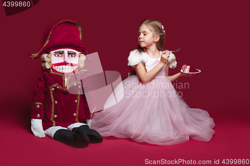 Image of The beauty ballerina standing with nutcracker