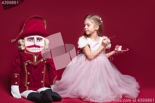 Image of The beauty ballerina standing with nutcracker