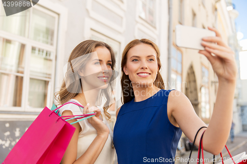 Image of women shopping and taking selfie by smartphone