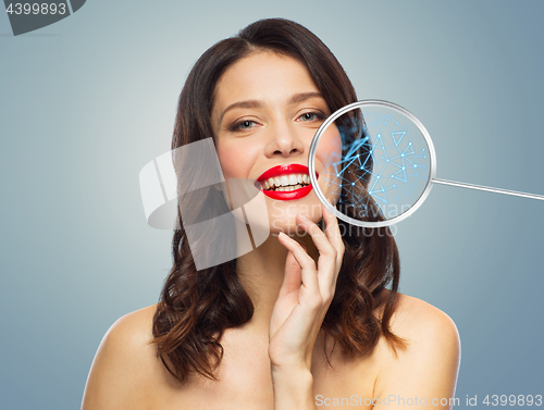 Image of beautiful smiling woman with magnifying glass