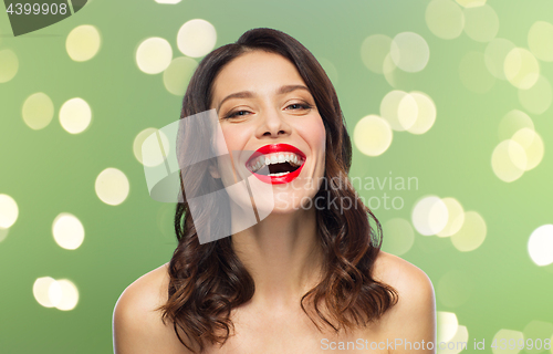 Image of beautiful laughing young woman with red lipstick