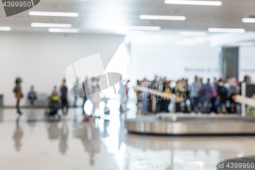 Image of Blured image of people waiting for their luggage at airport arrival hall.