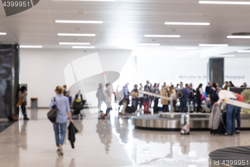 Image of Blured image of people waiting for their luggage at airport arrival hall.