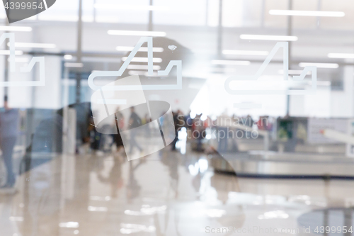 Image of Blured image of people waiting for their luggage at airport arrival hall.