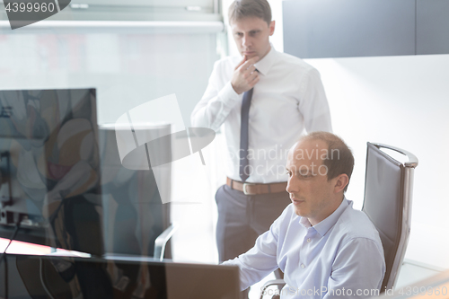 Image of Business team analyzing data at business meeting.