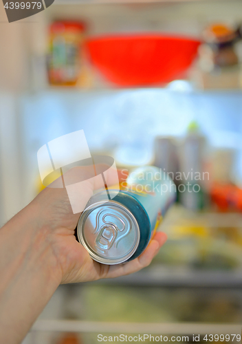 Image of Man taking beer from fridge