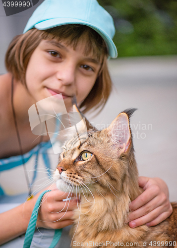 Image of Girl with cat in park