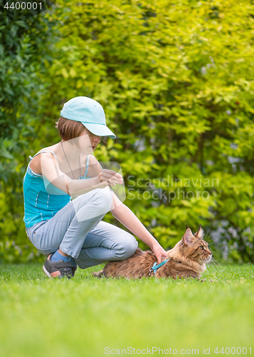 Image of Girl with cat in park