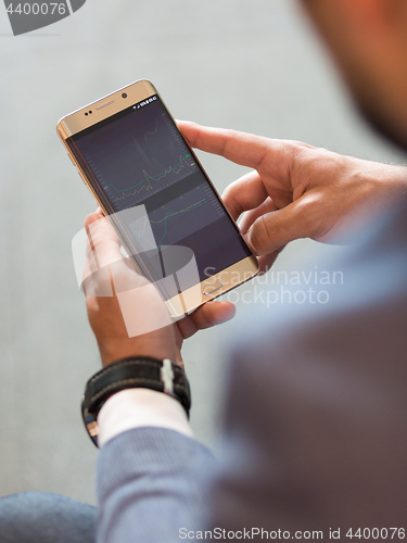 Image of Close up of businessman using mobile smart phone.