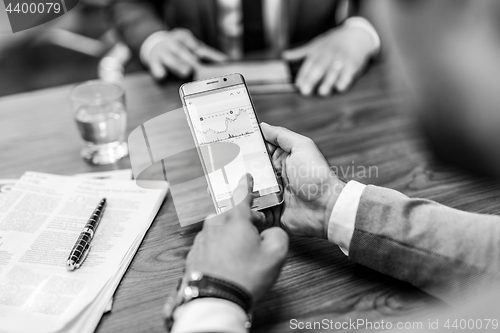 Image of Close up of businessman using mobile smart phone.