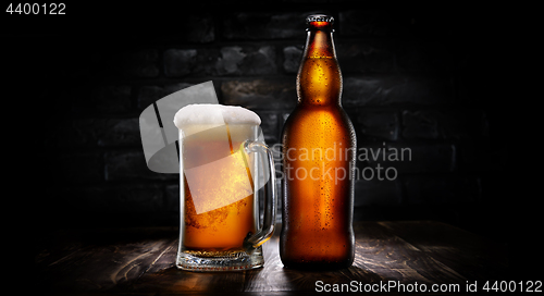 Image of Beer in mug and bottle on black