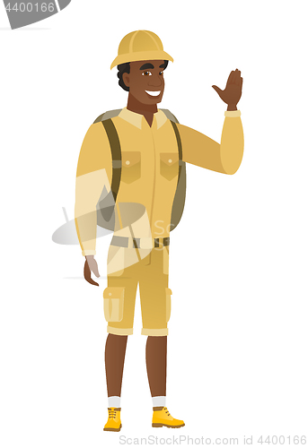 Image of Young african-american traveler waving his hand.