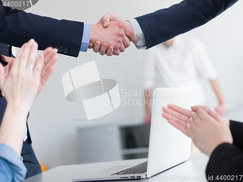 Image of cloasing the deal in modern office interior