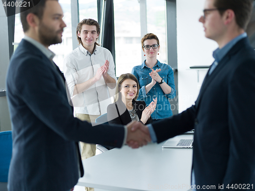 Image of cloasing the deal in modern office interior