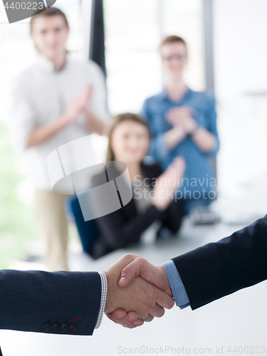 Image of cloasing the deal in modern office interior