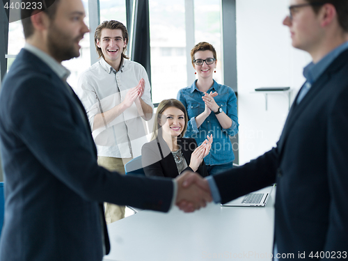 Image of cloasing the deal in modern office interior