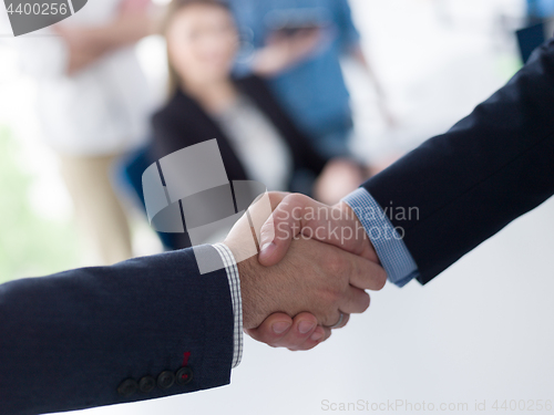 Image of cloasing the deal in modern office interior