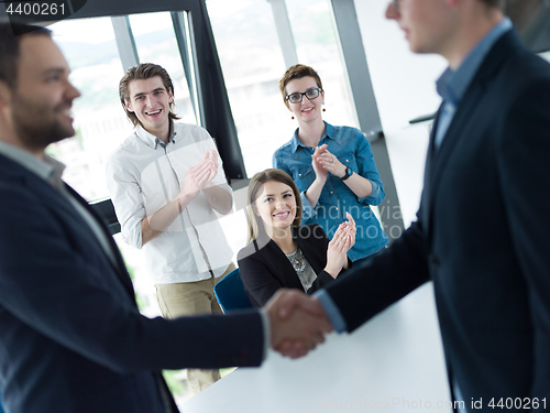 Image of cloasing the deal in modern office interior