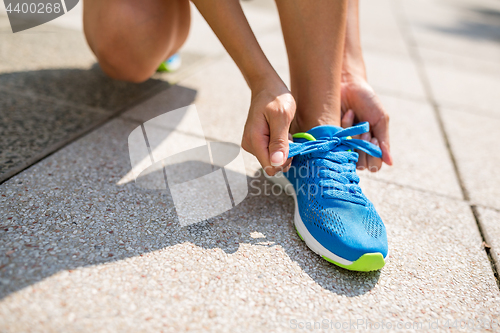 Image of Woman trying shoelace