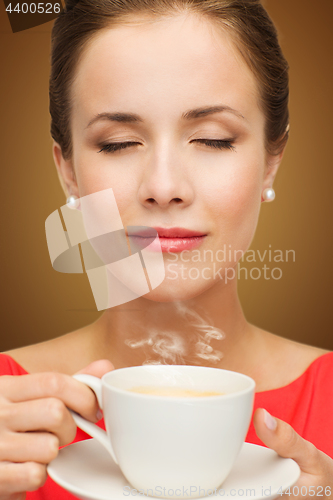 Image of beautiful woman in red dress with cup of coffee