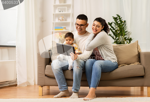 Image of mother, father and baby with tablet pc at home