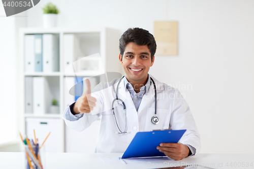 Image of happy doctor at clinic showing thumbs up