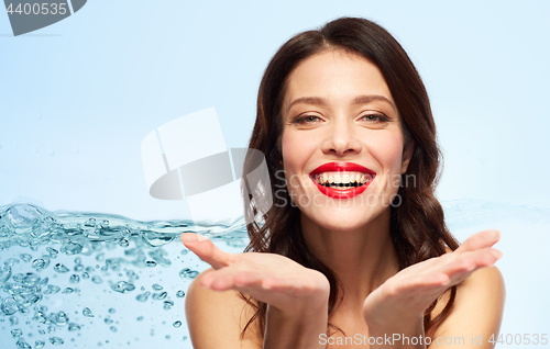 Image of beautiful smiling young woman with red lipstick