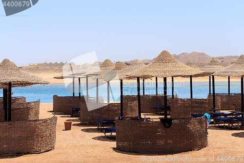 Image of Beach sun parasol and blue sky, holliday in Egypt