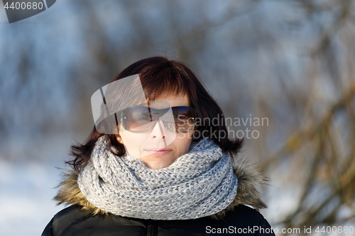 Image of woman with sunglasses without makeup in winter time