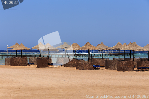 Image of Beach sun parasol and blue sky, holliday in Egypt