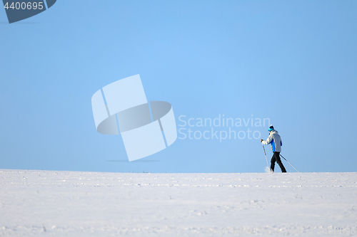 Image of unidentified skier on the horizon winter landscape